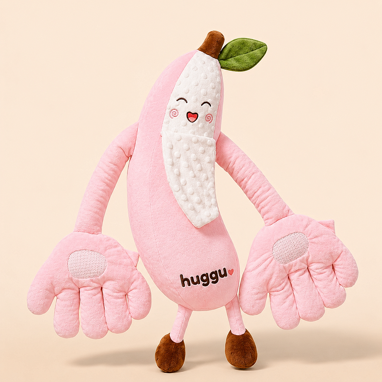 Betty the Banana plush — pink with embroidered huggu wordmark